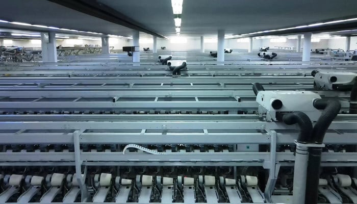 Rows of modern automated spinning frames in a bright partner mill