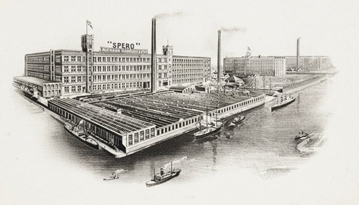 Engraving of the Spero mills of Richard Haworth and Co, with chimneys, warehouses and ships alongside