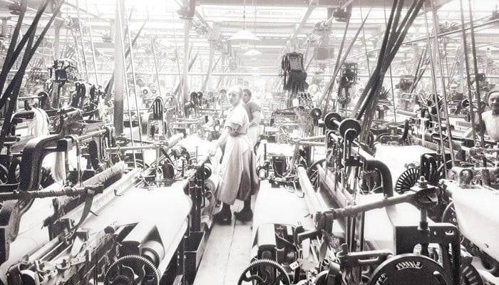 Workers weaving Spero cloth among rows of looms in the Richard Haworth mills